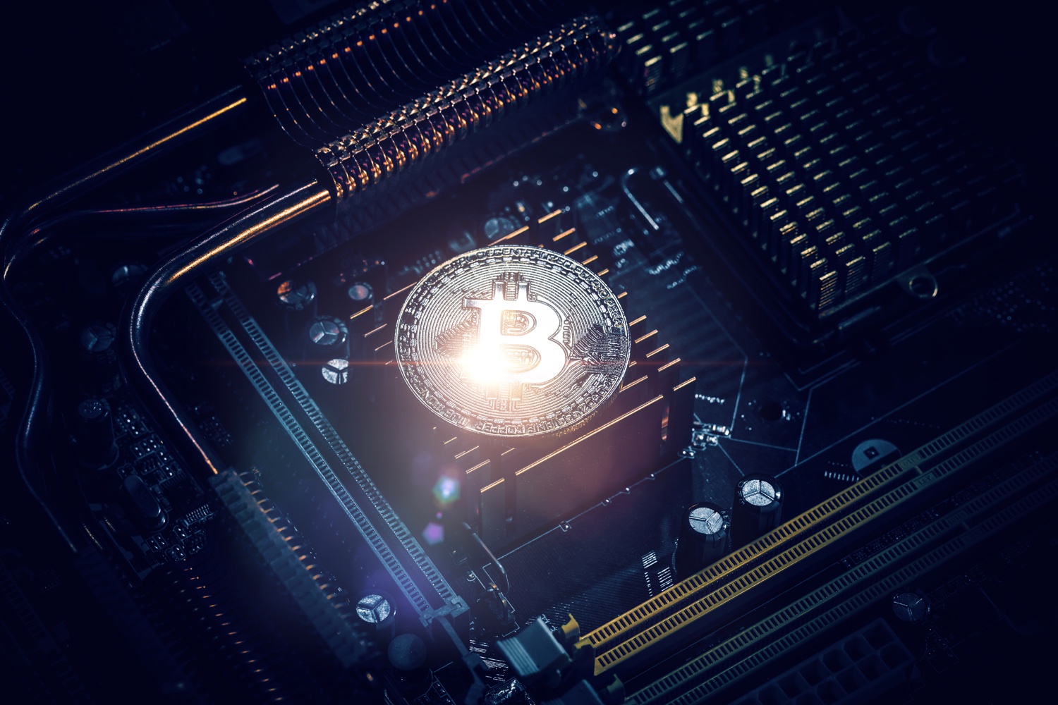 a bitcoin coin on a black computer circuit